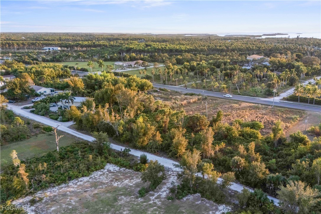 13721 Hampton Road Bokeelia, FL 33922 - Photo 2 of 9 an aerial view of residential building with outdoor space and trees