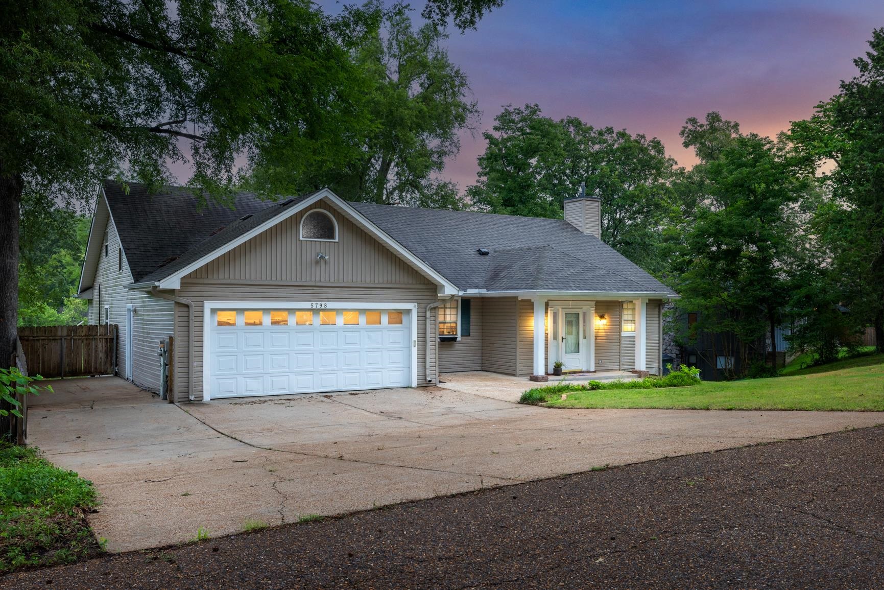 5798 North Sunset Point Memphis, TN 38135 - Photo 12 of 40 a front view of a house with a yard and garage