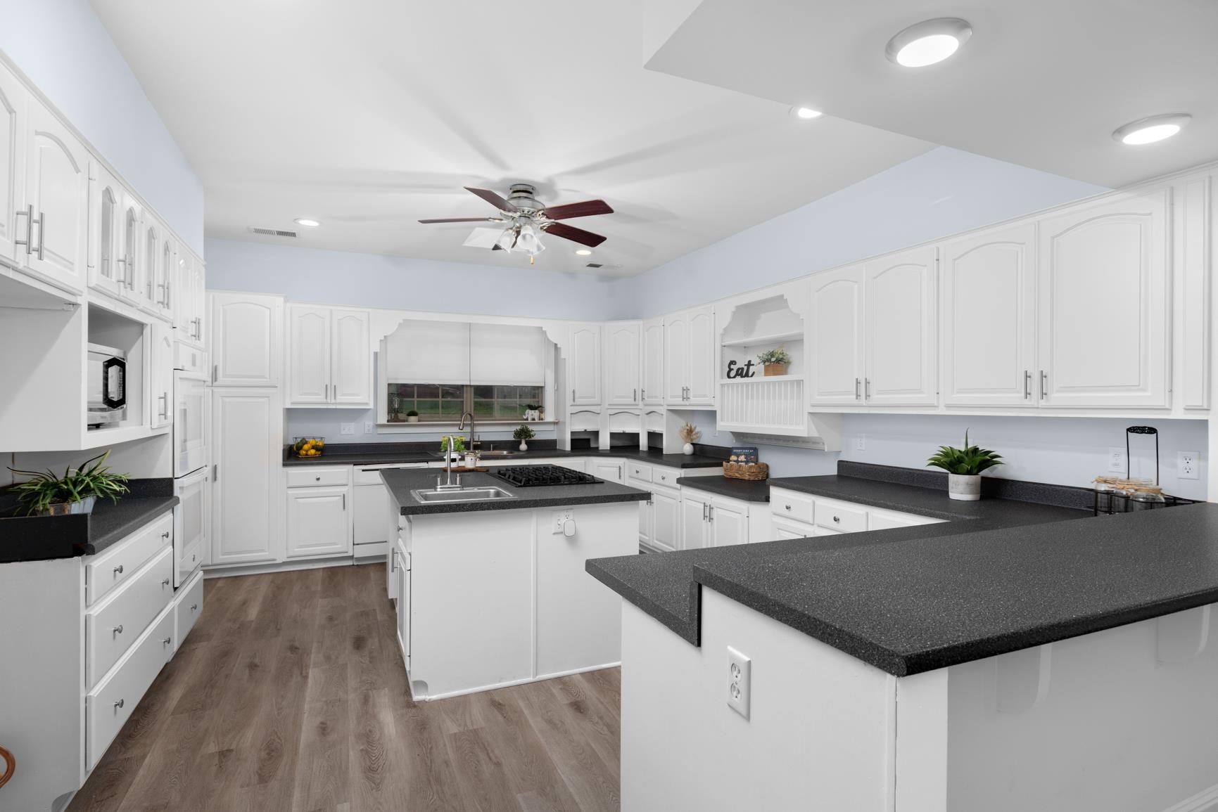 5798 North Sunset Point Memphis, TN 38135 - Photo 20 of 40 a kitchen with granite countertop a sink a counter top space appliances and cabinets