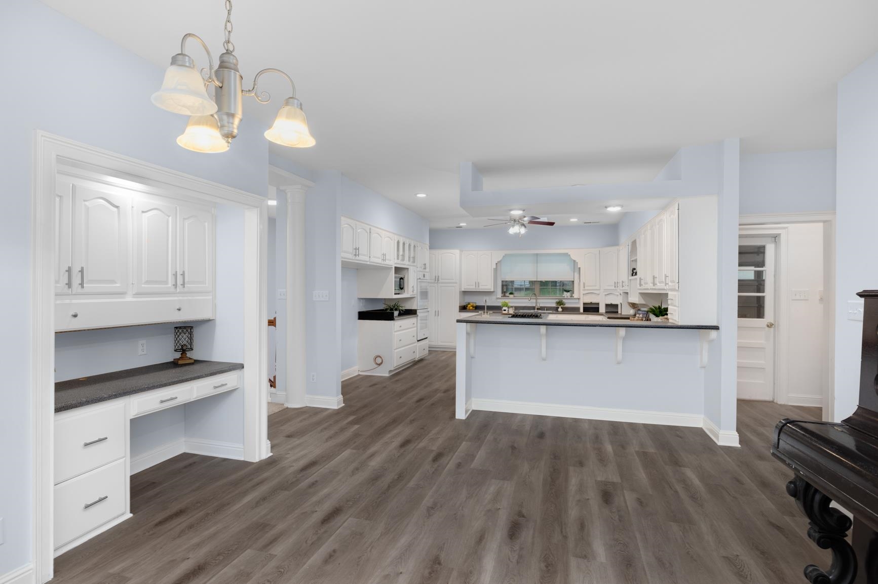 5798 North Sunset Point Memphis, TN 38135 - Photo 22 of 40 a large kitchen with white cabinets stainless steel appliances a dining table and chairs