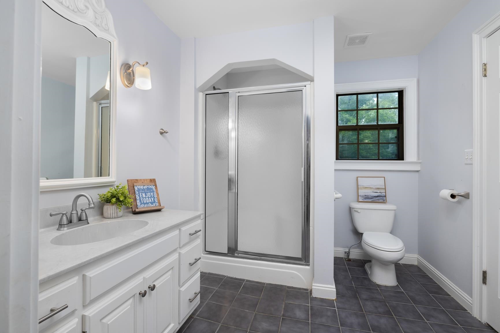 5798 North Sunset Point Memphis, TN 38135 - Photo 25 of 40 a bathroom with a sink a toilet and a mirror