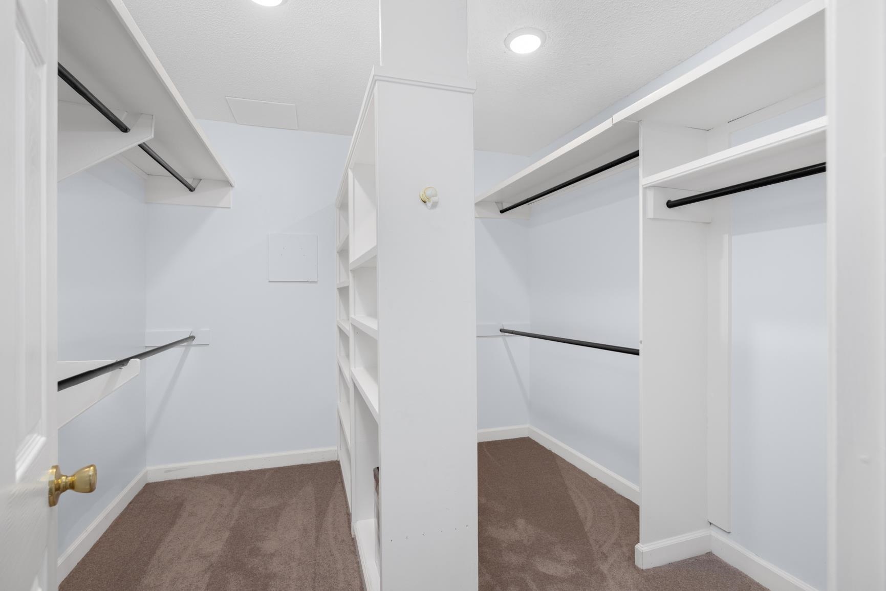 5798 North Sunset Point Memphis, TN 38135 - Photo 35 of 40 a view of walk in closet with empty racks
