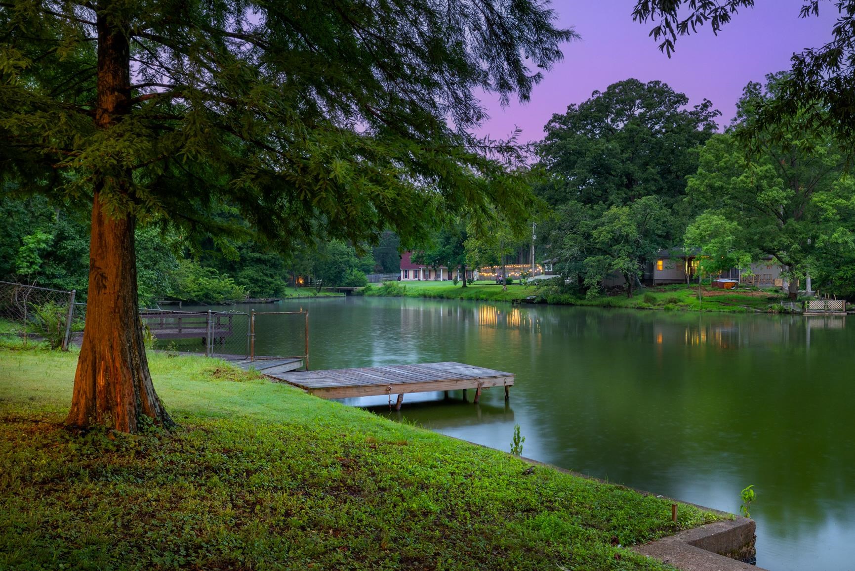 5798 North Sunset Point Memphis, TN 38135 - Photo 9 of 40 a body of water with a tree in the background