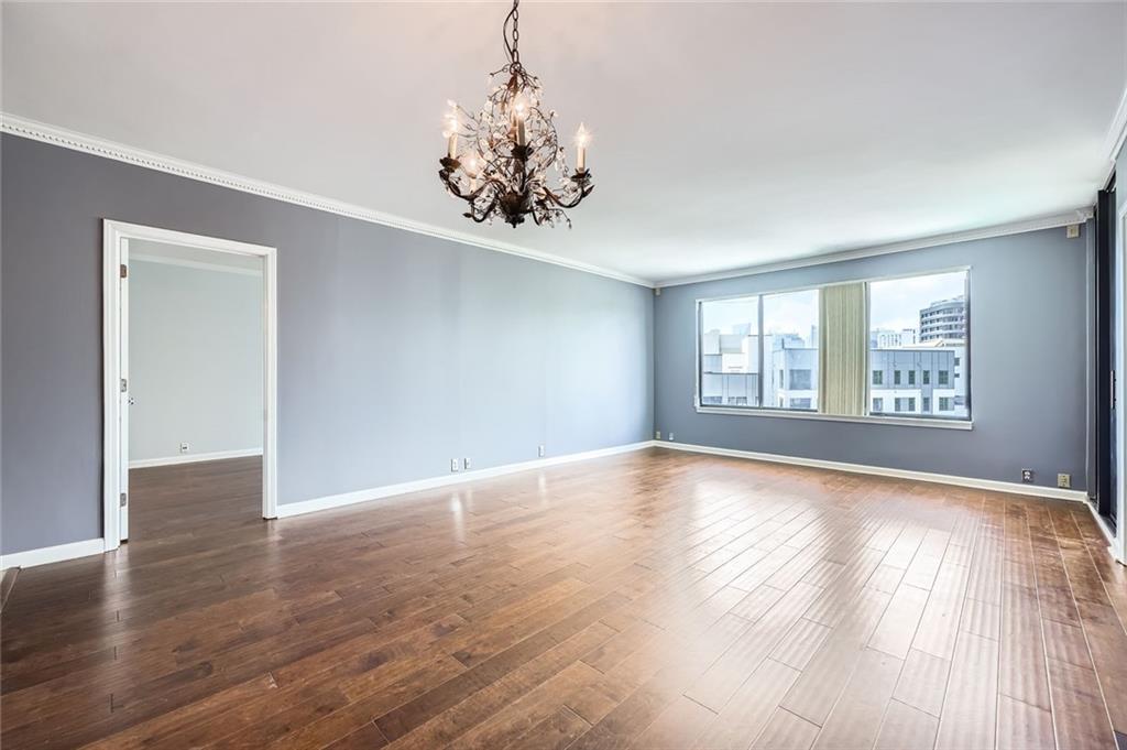 3481 Lakeside Drive Northeast, Unit 1107 Atlanta, GA 30326 - Photo 11 of 35 a view of an empty room with wooden floor and a window