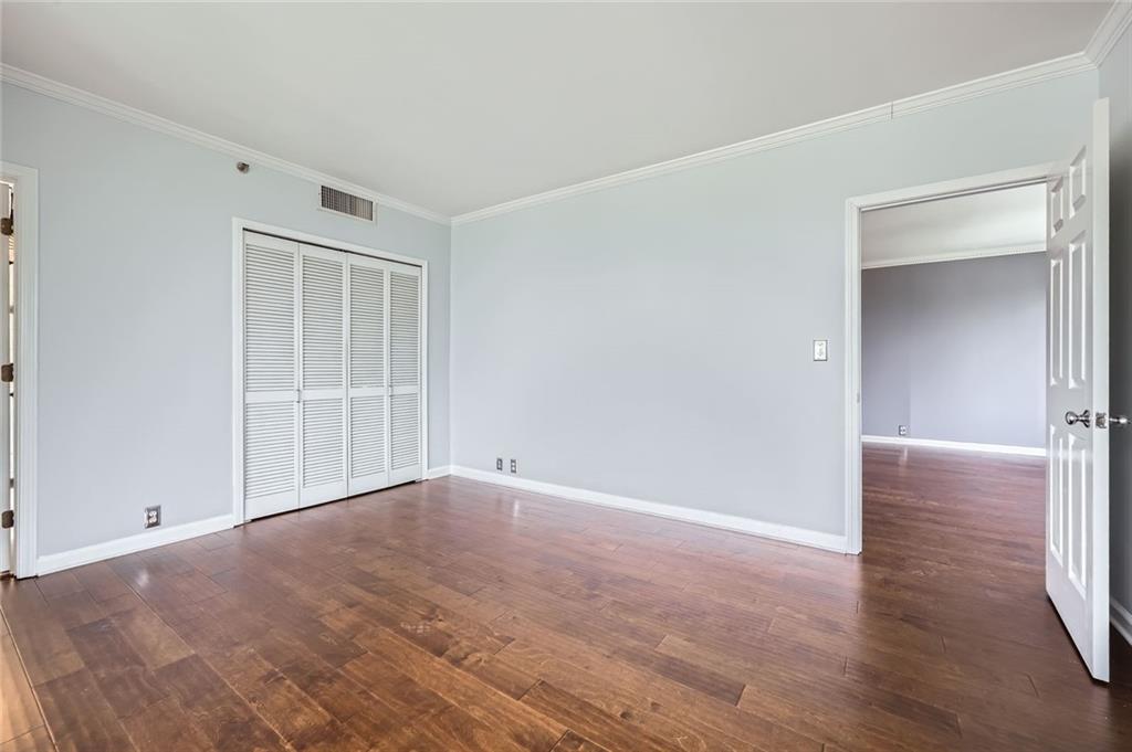 3481 Lakeside Drive Northeast, Unit 1107 Atlanta, GA 30326 - Photo 14 of 35 a view of an empty room with wooden floor