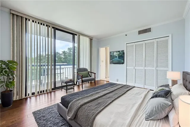 a bedroom with a large bed and a large window