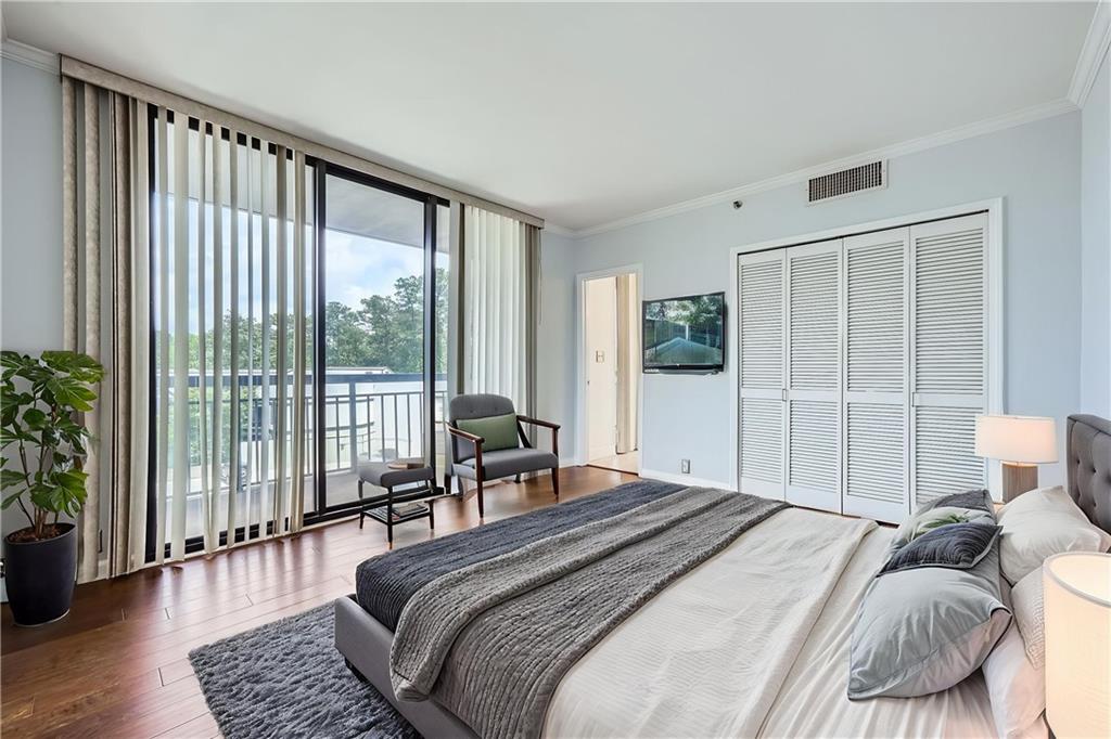 3481 Lakeside Drive Northeast, Unit 1107 Atlanta, GA 30326 - Photo 16 of 35 a bedroom with a large bed and a large window