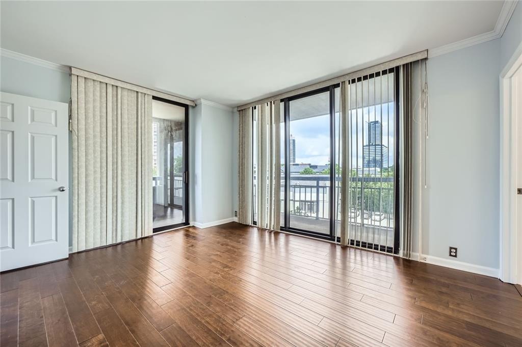 3481 Lakeside Drive Northeast, Unit 1107 Atlanta, GA 30326 - Photo 17 of 35 a view of an empty room with wooden floor and a window