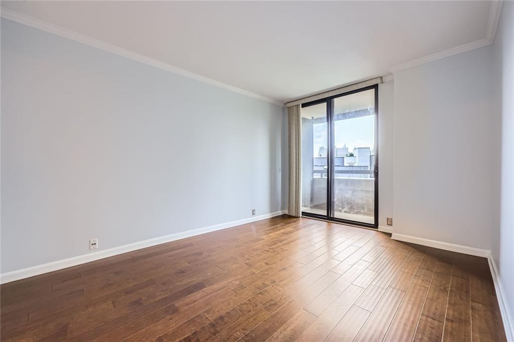 3481 Lakeside Drive Northeast, Unit 1107 Atlanta, GA 30326 - Photo 21 of 35 an empty room with wooden floor and windows