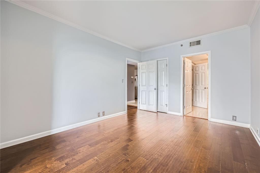 3481 Lakeside Drive Northeast, Unit 1107 Atlanta, GA 30326 - Photo 24 of 35 a view of an empty room with wooden floor and closet