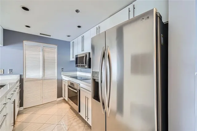 a kitchen with stainless steel appliances a refrigerator and a sink