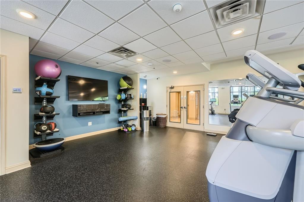 3481 Lakeside Drive Northeast, Unit 1107 Atlanta, GA 30326 - Photo 33 of 35 a living room with furniture and a flat screen tv