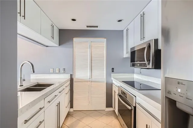 a kitchen with a sink stove and refrigerator