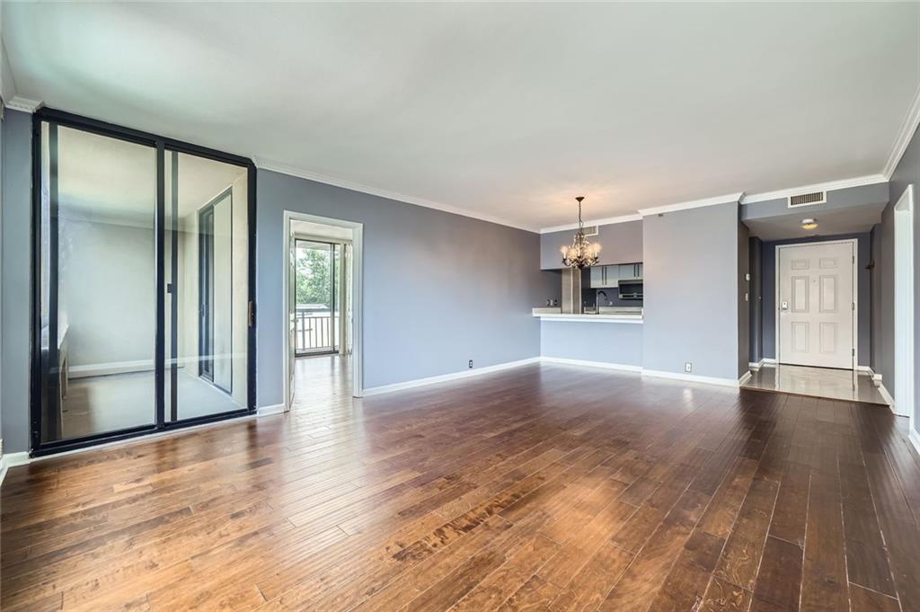 3481 Lakeside Drive Northeast, Unit 1107 Atlanta, GA 30326 - Photo 7 of 35 a view of a big room with wooden floor and windows