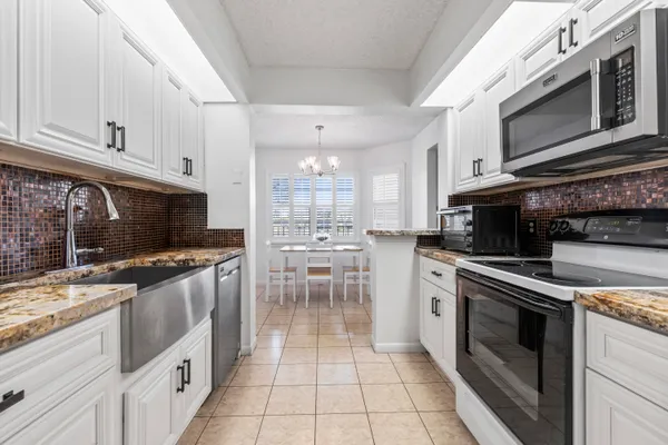 a kitchen with stainless steel appliances granite countertop a sink and cabinets