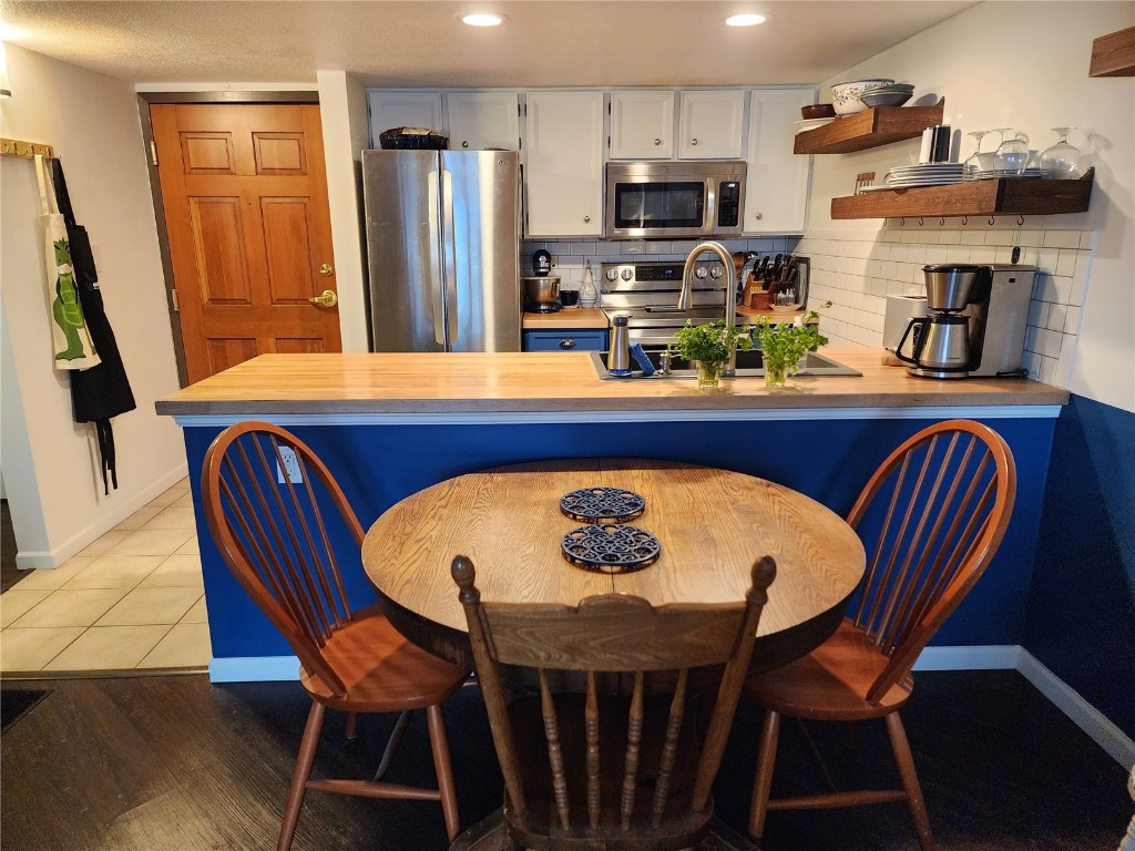 57 Copper Circle, Unit 104 Copper Mountain, CO 80443 - Photo 15 of 25 a view of a dining room with furniture and wooden floor