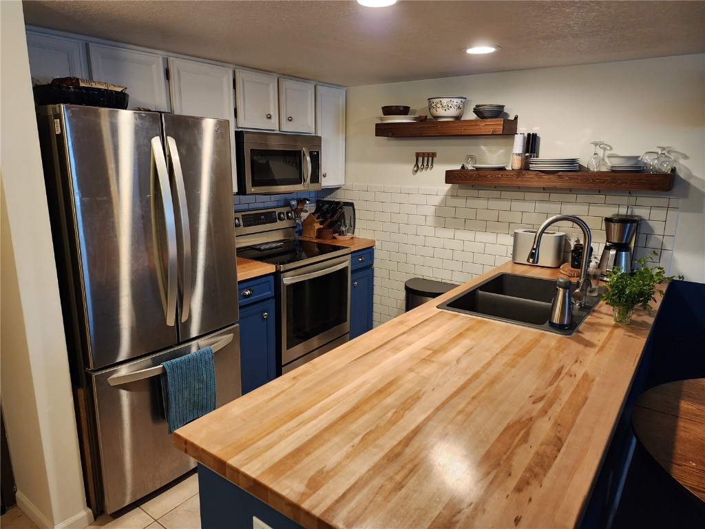 57 Copper Circle, Unit 104 Copper Mountain, CO 80443 - Photo 3 of 25 a kitchen with stainless steel appliances a refrigerator a stove a sink and a refrigerator