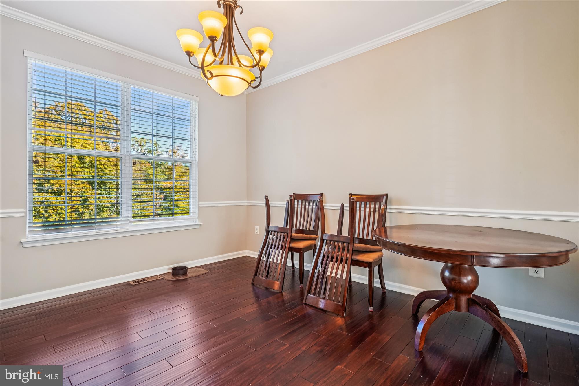 3318 Eagle Ridge Drive Woodbridge, VA 22191 - Photo 12 of 72 a dining room with wooden floor a chandelier a wooden table and chairs