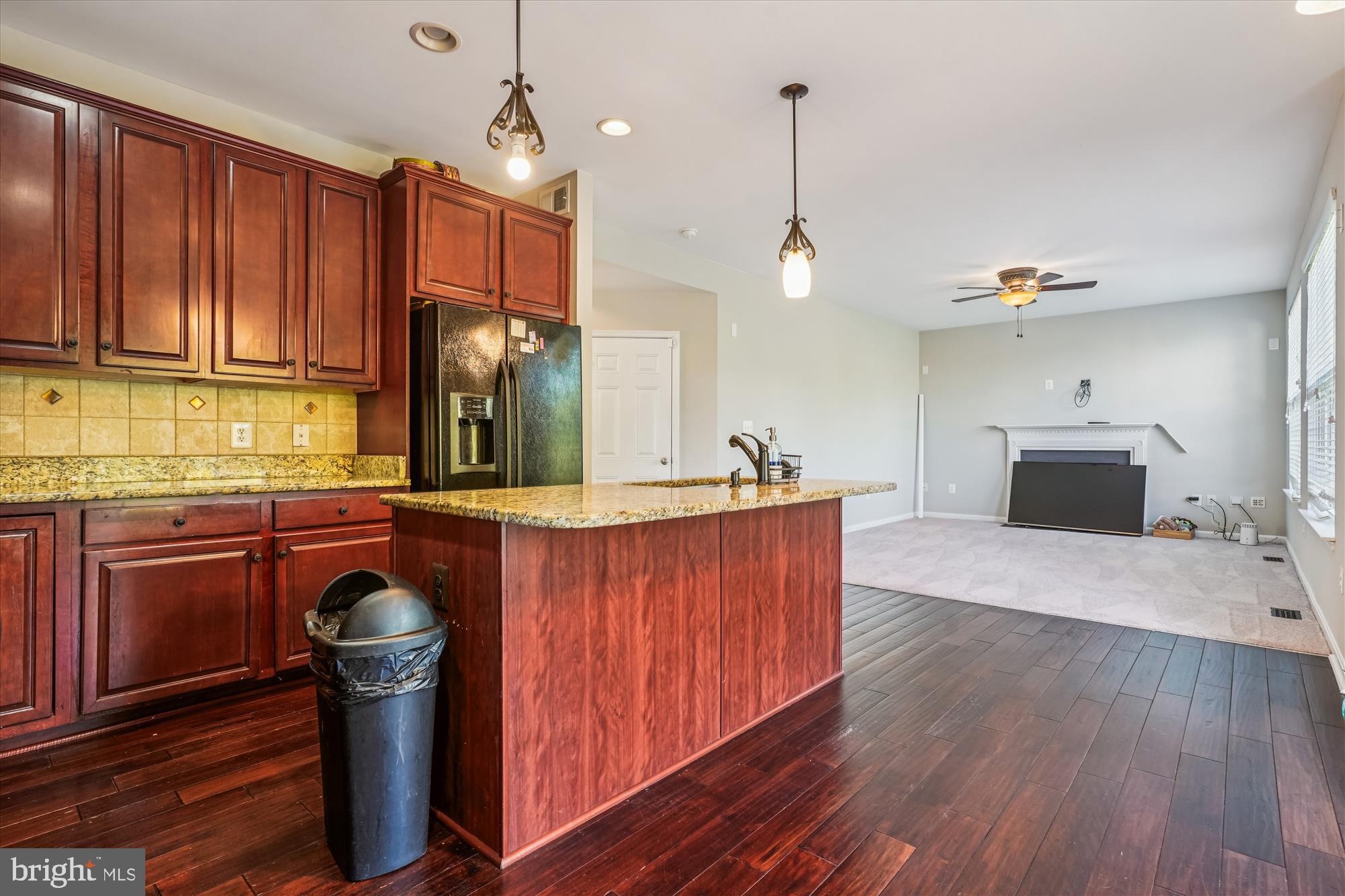 3318 Eagle Ridge Drive Woodbridge, VA 22191 - Photo 13 of 72 a kitchen with kitchen island granite countertop wooden cabinets and a stove