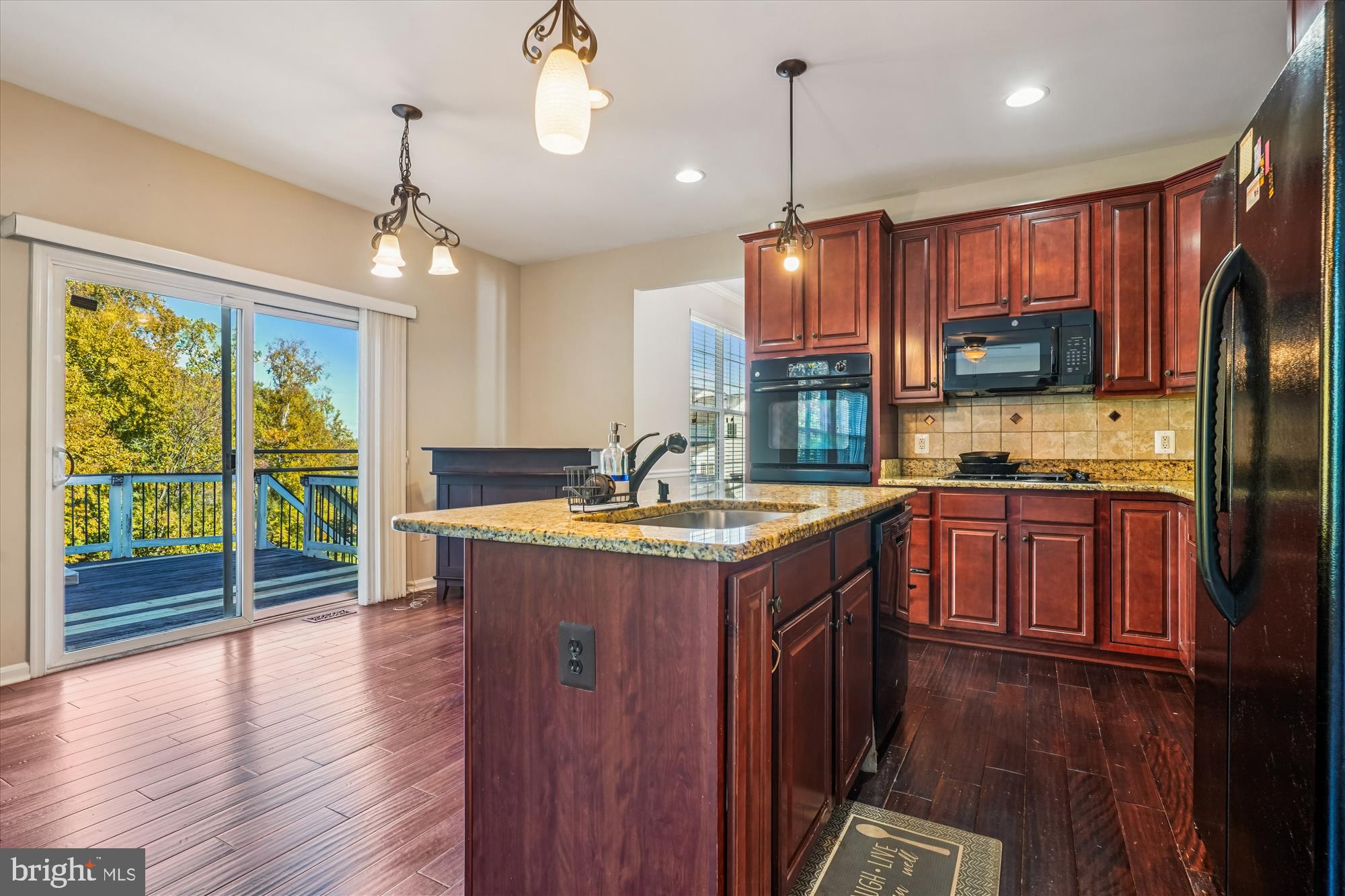 3318 Eagle Ridge Drive Woodbridge, VA 22191 - Photo 15 of 72 a kitchen with kitchen island granite countertop wooden floors granite counter tops a stove and a center island