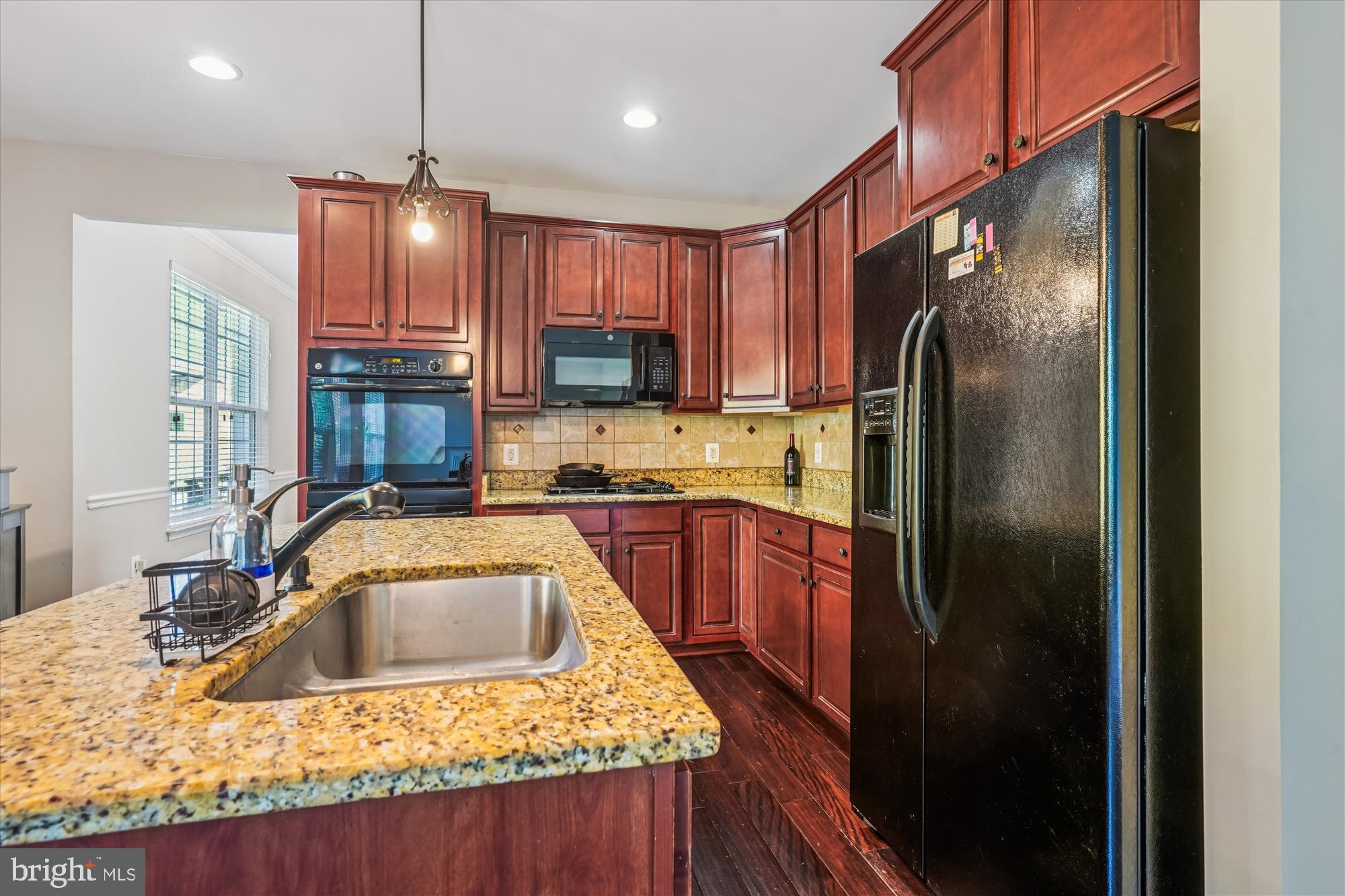 3318 Eagle Ridge Drive Woodbridge, VA 22191 - Photo 17 of 72 a kitchen with stainless steel appliances granite countertop a sink refrigerator and microwave