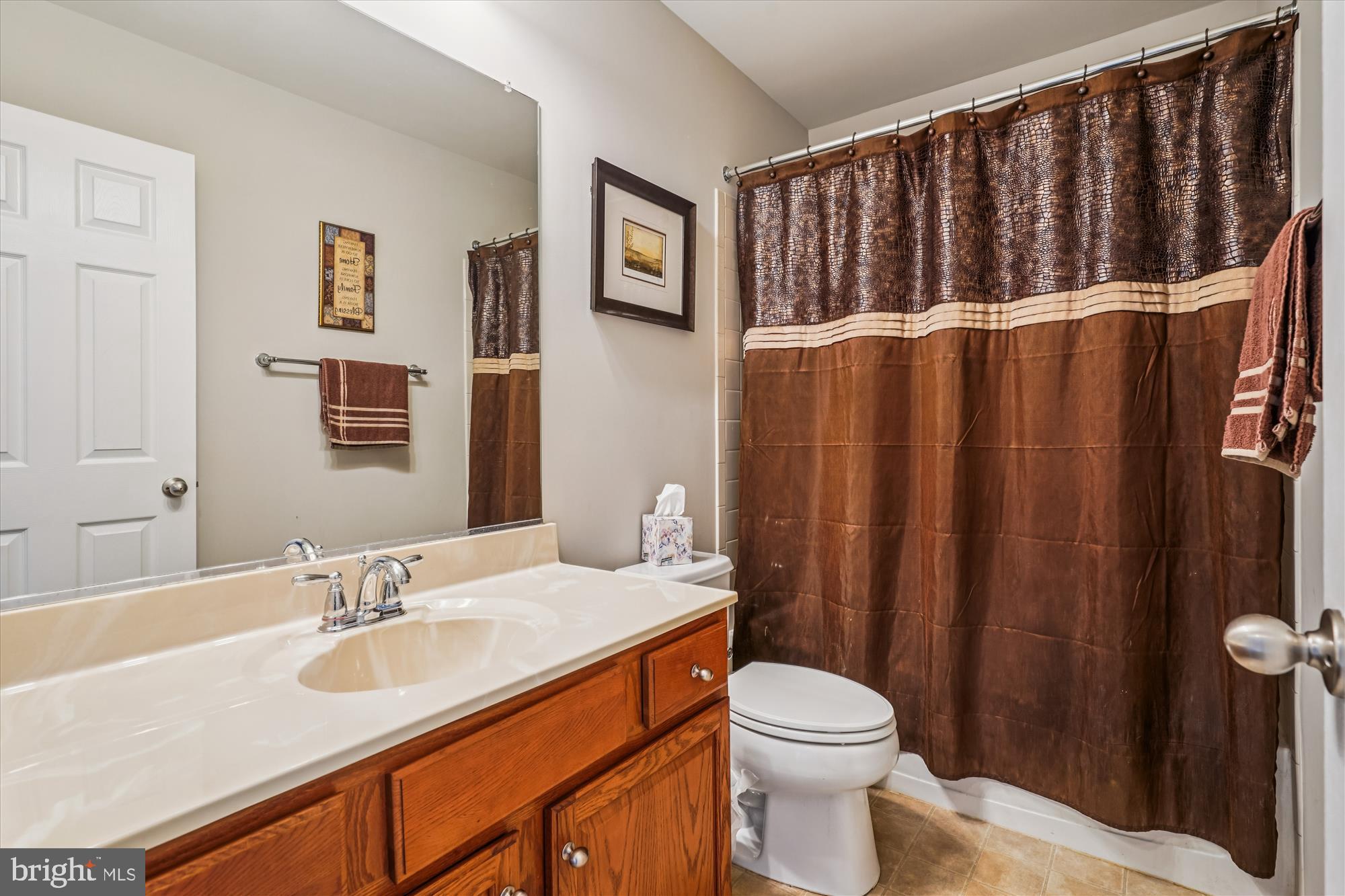 3318 Eagle Ridge Drive Woodbridge, VA 22191 - Photo 34 of 72 a bathroom with a sink a toilet and shower curtain