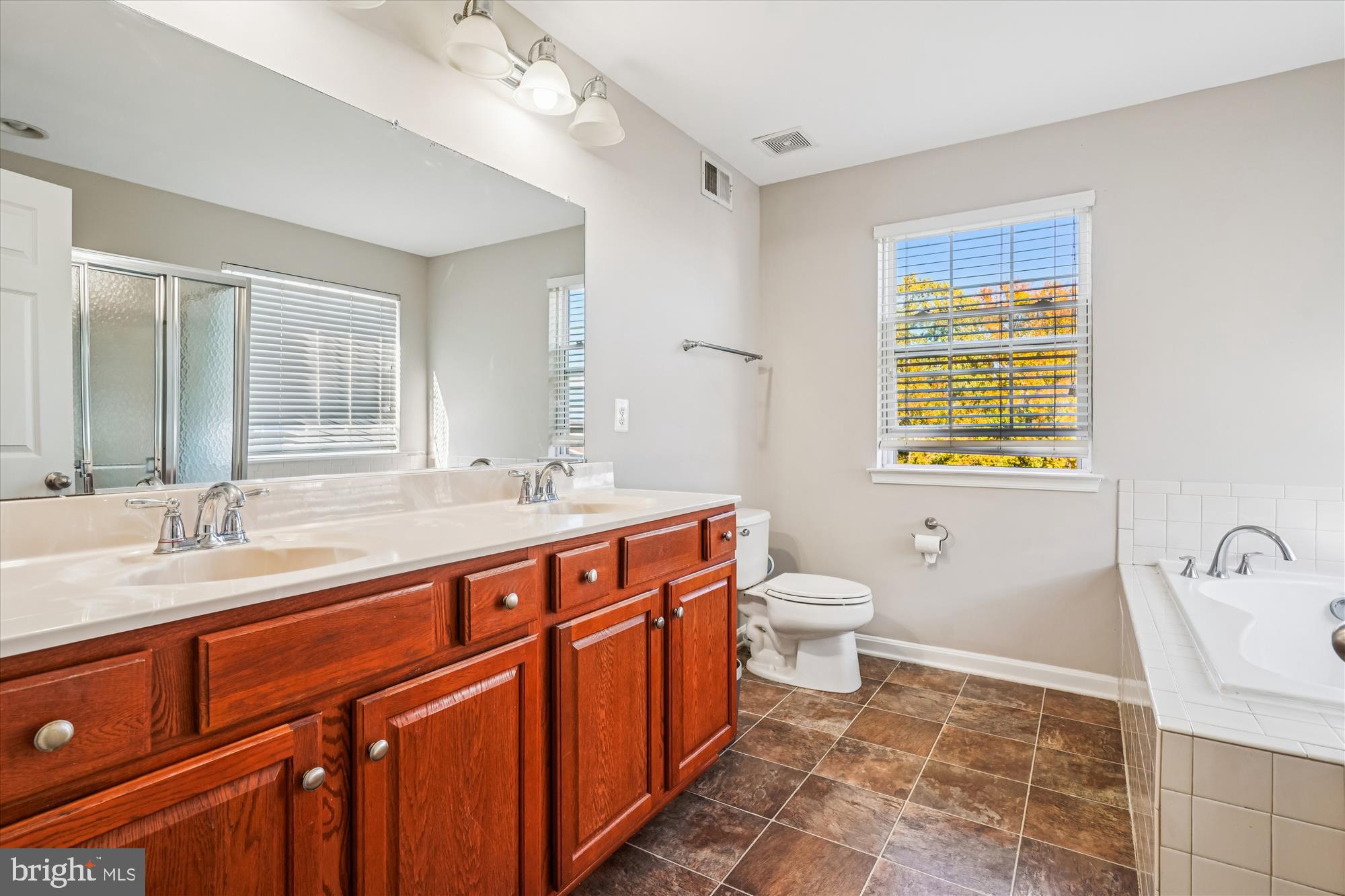 3318 Eagle Ridge Drive Woodbridge, VA 22191 - Photo 39 of 72 a spacious bathroom with a double vanity sink toilet and a tub