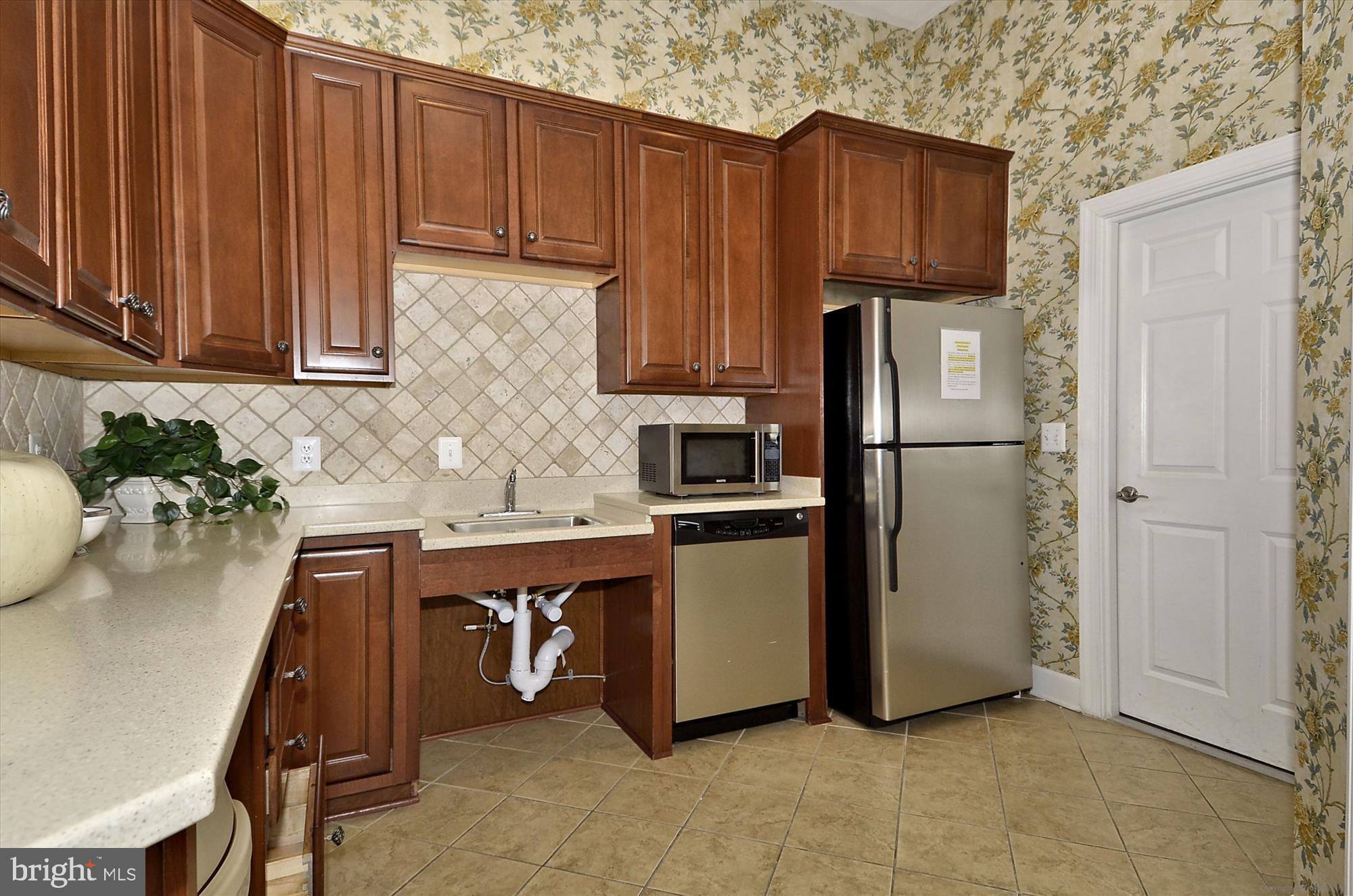 3318 Eagle Ridge Drive Woodbridge, VA 22191 - Photo 64 of 72 a kitchen with stainless steel appliances granite countertop a refrigerator a sink dishwasher and wooden cabinets with a granite countertops