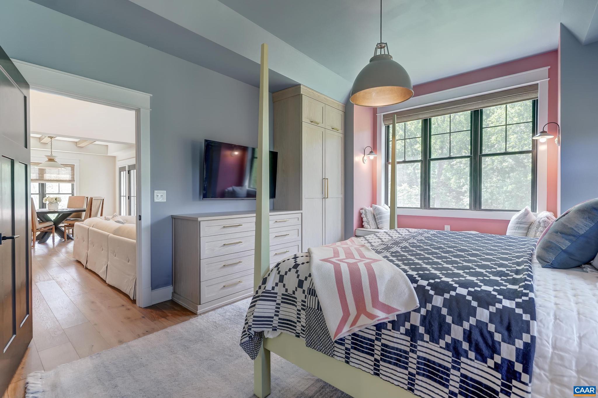 3327 Rowcross Street Crozet, VA 22932 - Photo 26 of 63 a bedroom with a large bed and a flat tv screen