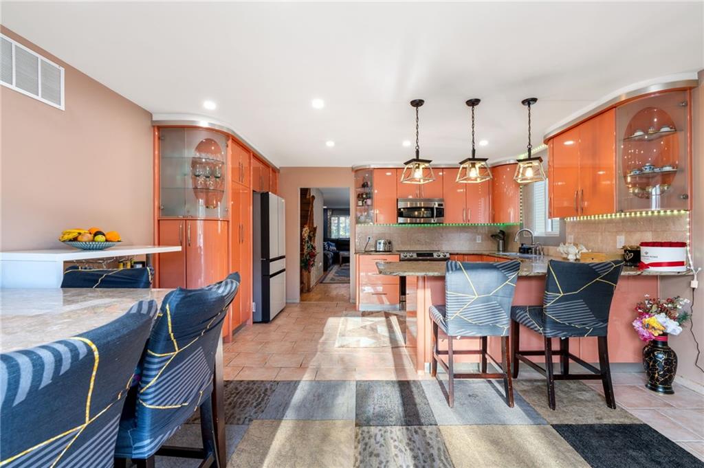 1314 East 69th Street Brooklyn, NY 11234 - Photo 13 of 42 a dining room with furniture and a view of kitchen
