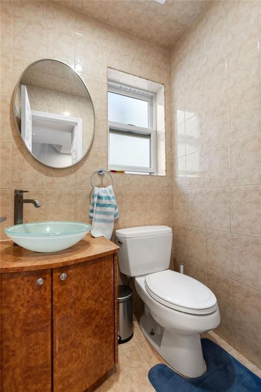 1314 East 69th Street Brooklyn, NY 11234 - Photo 14 of 42 a bathroom with a toilet a sink and a mirror