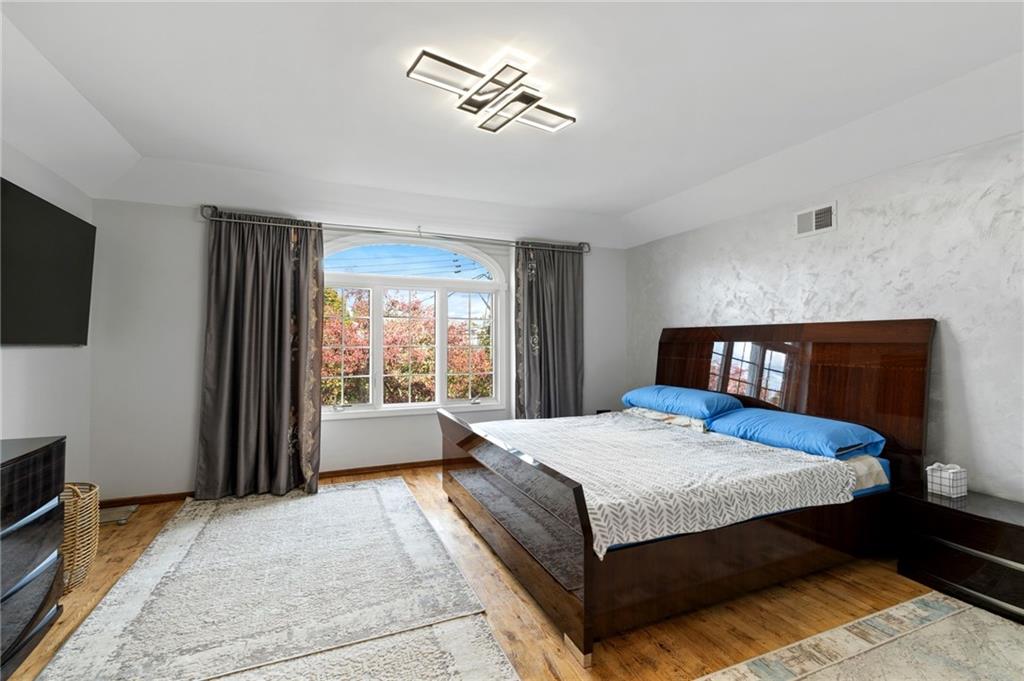 1314 East 69th Street Brooklyn, NY 11234 - Photo 16 of 42 a bedroom with a bed and a television