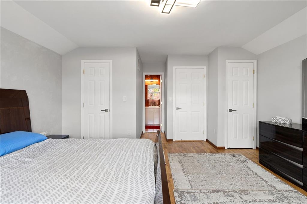 1314 East 69th Street Brooklyn, NY 11234 - Photo 19 of 42 a bedroom with a bed and wooden floor