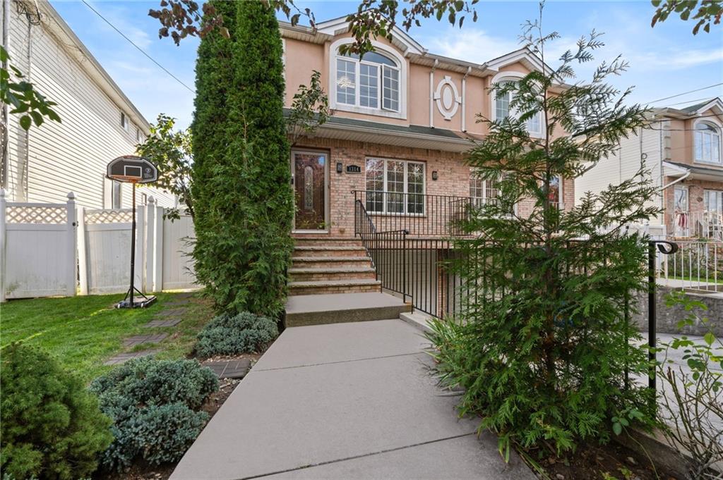 1314 East 69th Street Brooklyn, NY 11234 - Photo 2 of 42 a front view of a house with garden