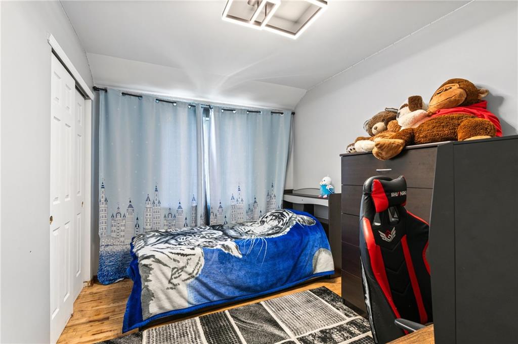 1314 East 69th Street Brooklyn, NY 11234 - Photo 22 of 42 a living room with furniture and a potted plant