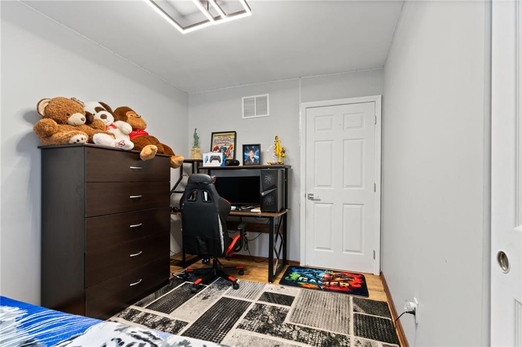 1314 East 69th Street Brooklyn, NY 11234 - Photo 23 of 42 a room with furniture and wooden floor