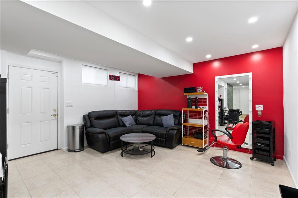 1314 East 69th Street Brooklyn, NY 11234 - Photo 29 of 42 a living room with furniture gym equipment and a gym machine