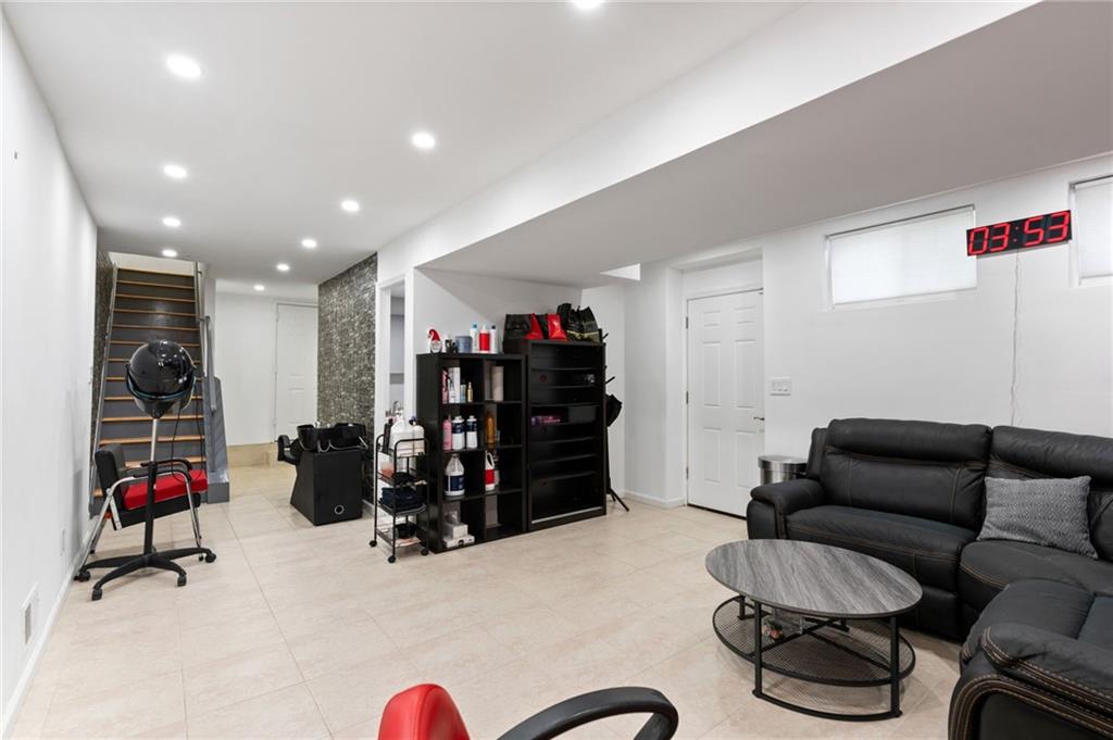 1314 East 69th Street Brooklyn, NY 11234 - Photo 30 of 42 a living room with furniture and gym equipment