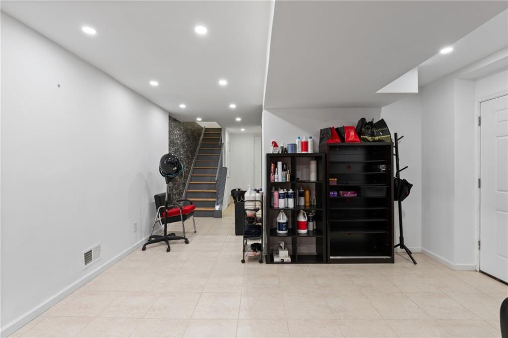 1314 East 69th Street Brooklyn, NY 11234 - Photo 31 of 42 a living room with lots of storage and a ceiling fan