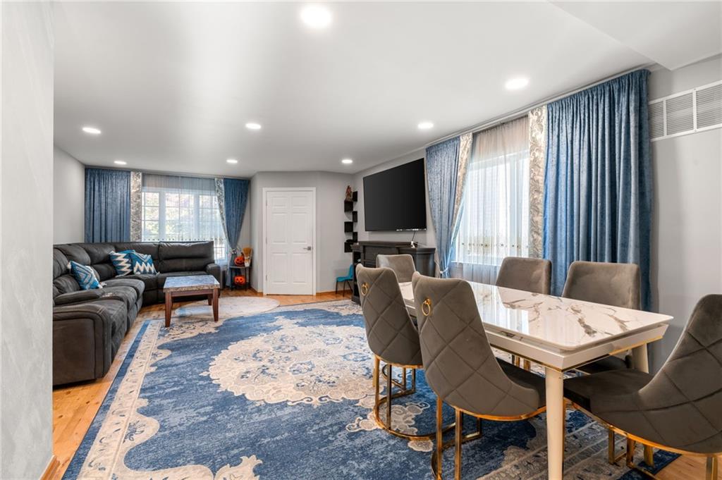 1314 East 69th Street Brooklyn, NY 11234 - Photo 5 of 42 a living room with furniture and a flat screen tv