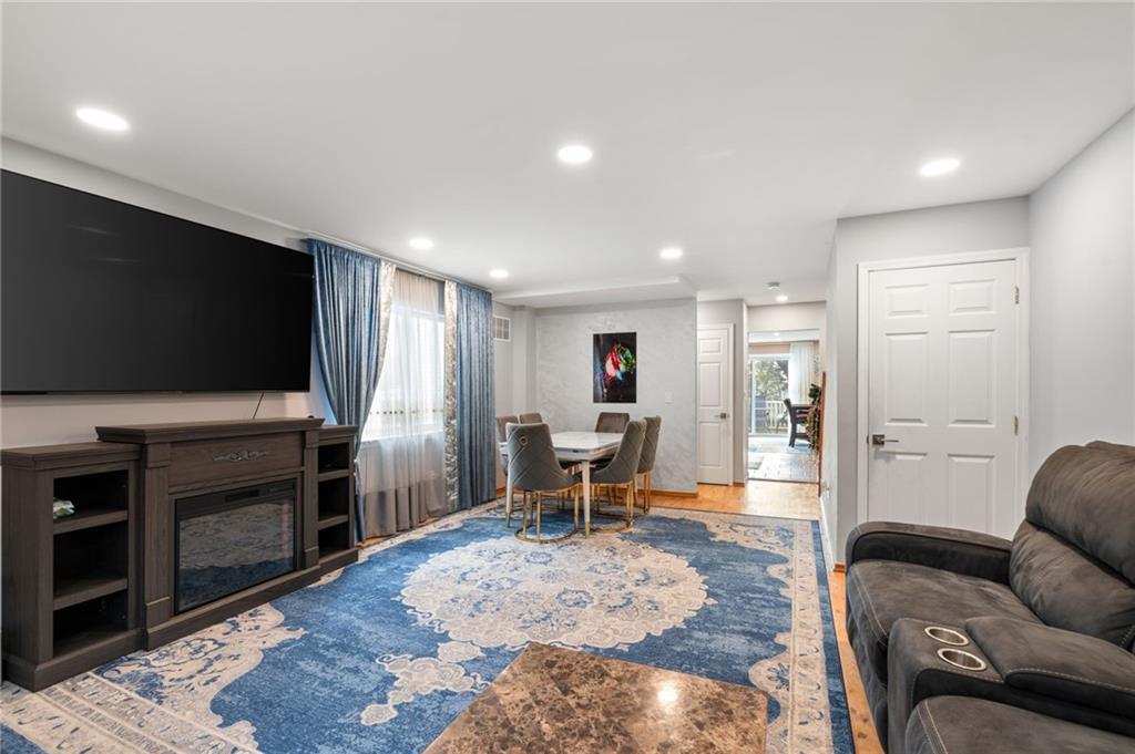 1314 East 69th Street Brooklyn, NY 11234 - Photo 7 of 42 a living room with furniture and a flat screen tv