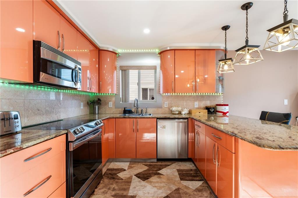 1314 East 69th Street Brooklyn, NY 11234 - Photo 9 of 42 a kitchen with stainless steel appliances granite countertop a sink stove and cabinets