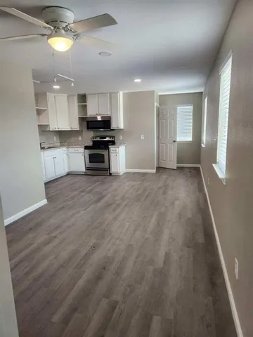 a view of kitchen with granite countertop lots of counter top space and appliances