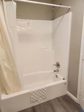 a bathroom with a bathtub and a shower