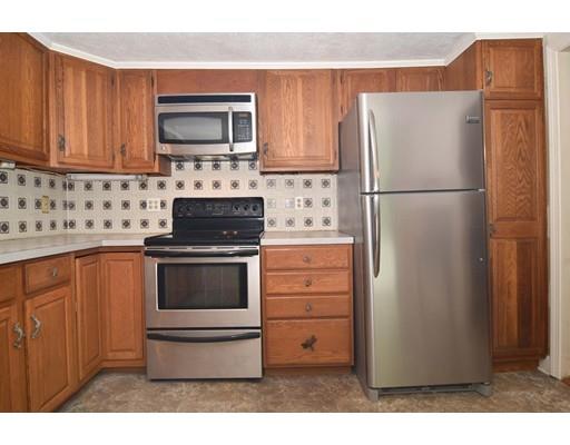 35 Cornell Road Westport, MA 02790 - Photo 12 of 38 a kitchen with granite countertop white cabinets and refrigerator