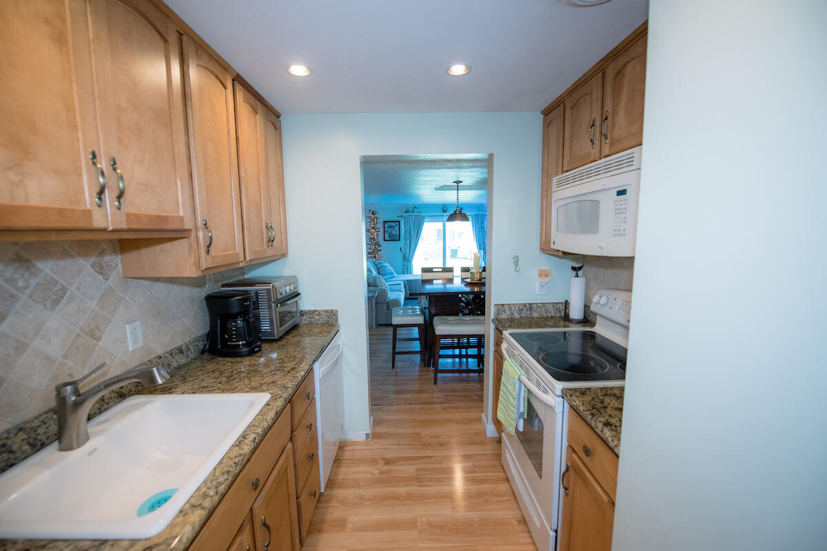 40 High Point Road, Unit B102 Tavernier, FL 33070 - Photo 17 of 27 a kitchen with a sink stove top oven and cabinets