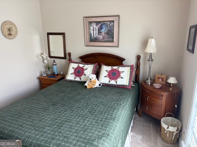610 Birch Lane Clarkesville, GA 30523 - Photo 43 of 46 a bedroom with a bed and a chandelier