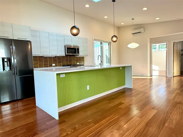 a view of a living room kitchen with furniture and a fireplace