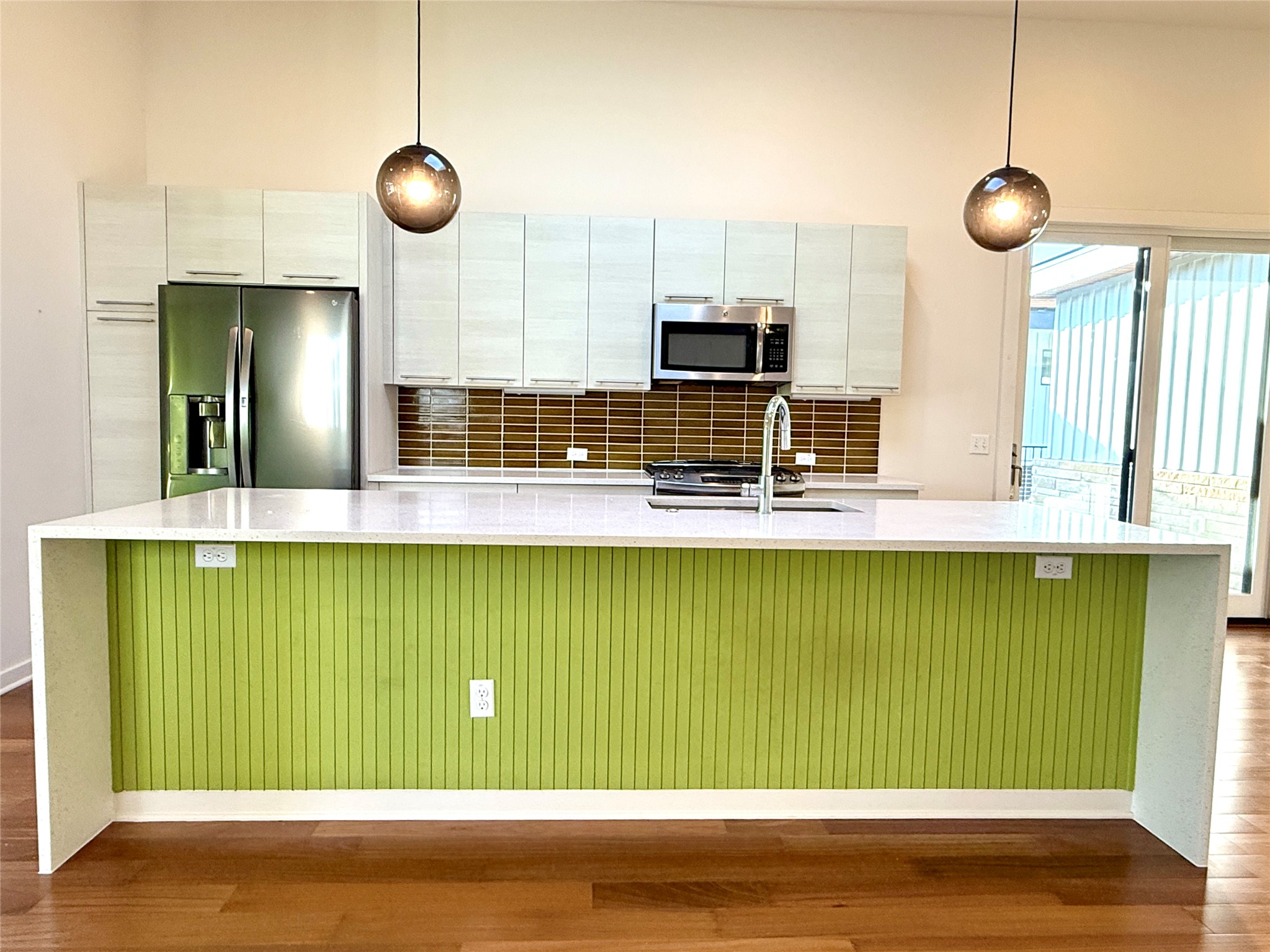 416 Starlight Village Loop Leander, TX 78641 - Photo 11 of 28 Kitchen with decorative backsplash, stainless steel appliances, pendant lighting, a large island, and dark wood finished floors