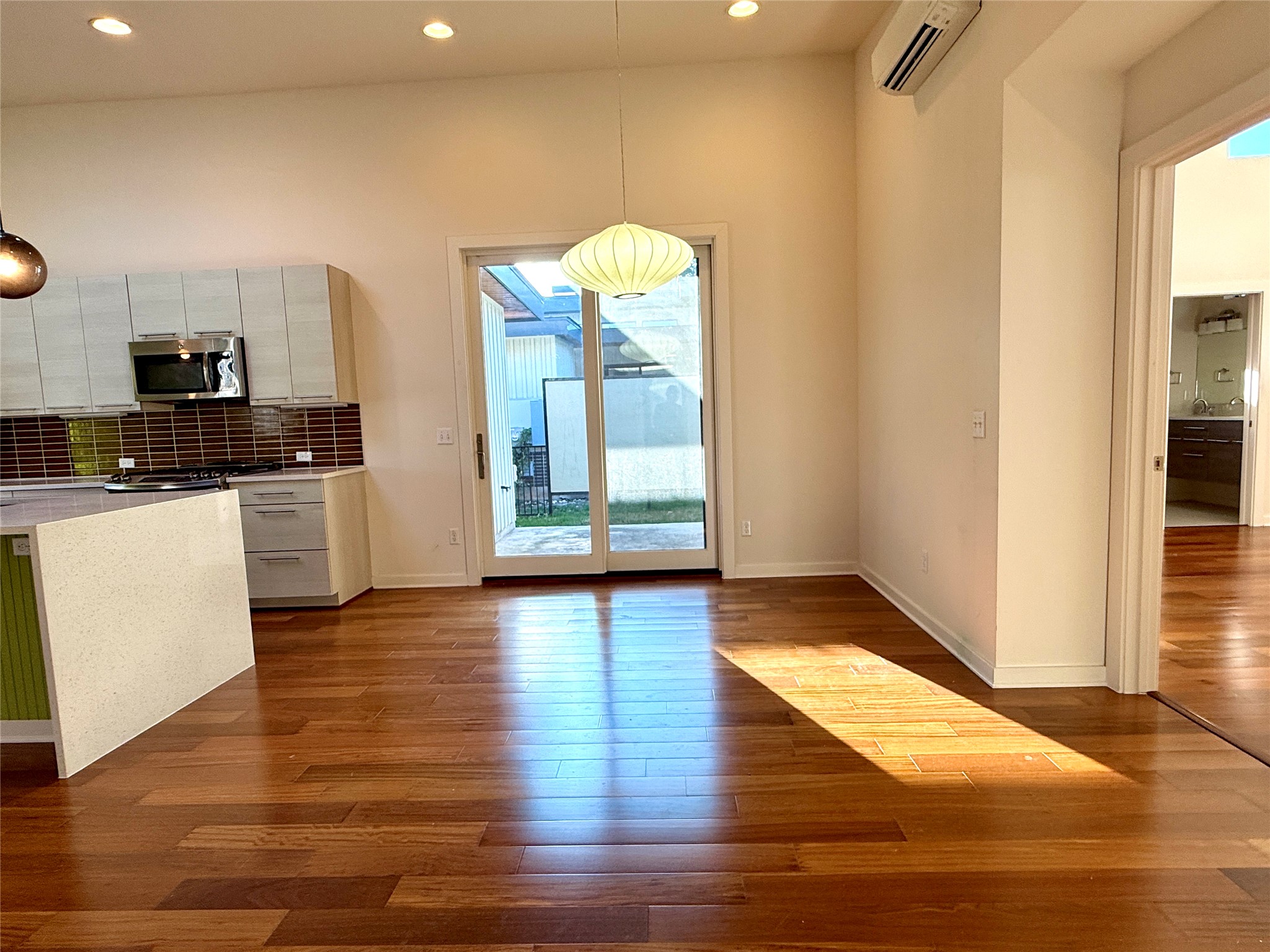 416 Starlight Village Loop Leander, TX 78641 - Photo 16 of 28 Unfurnished dining area with dark wood finished floors, a mini split for heating / cooling, and recessed lighting